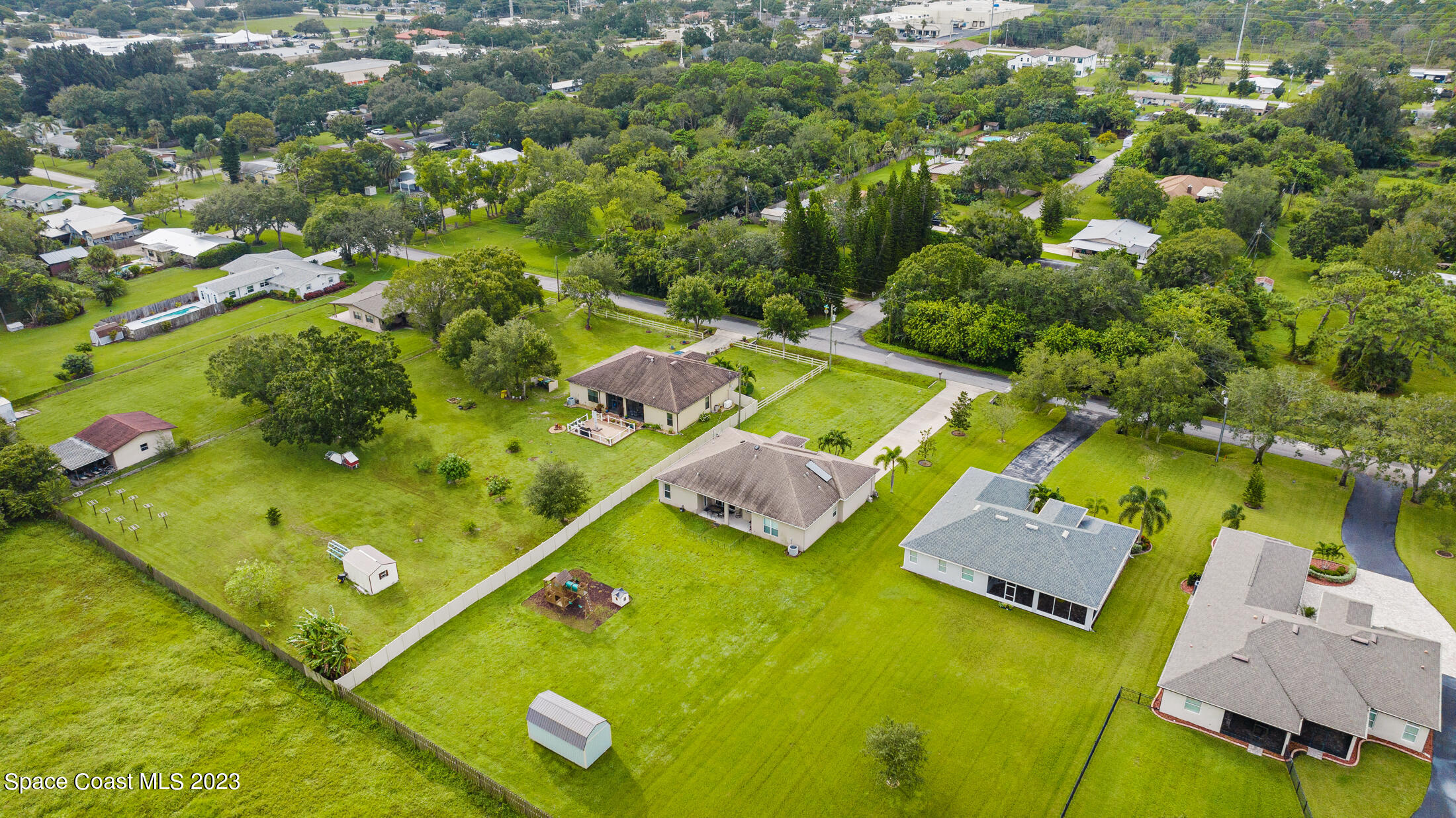 1840 Trimble Road Melbourne, FL 32934 - Photo 40 of 42 an aerial view of a pool yard residential house with outdoor space and trees