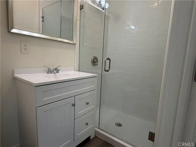 a bathroom with a sink a mirror and shower