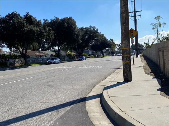 a street sign on a sidewalk next to a road