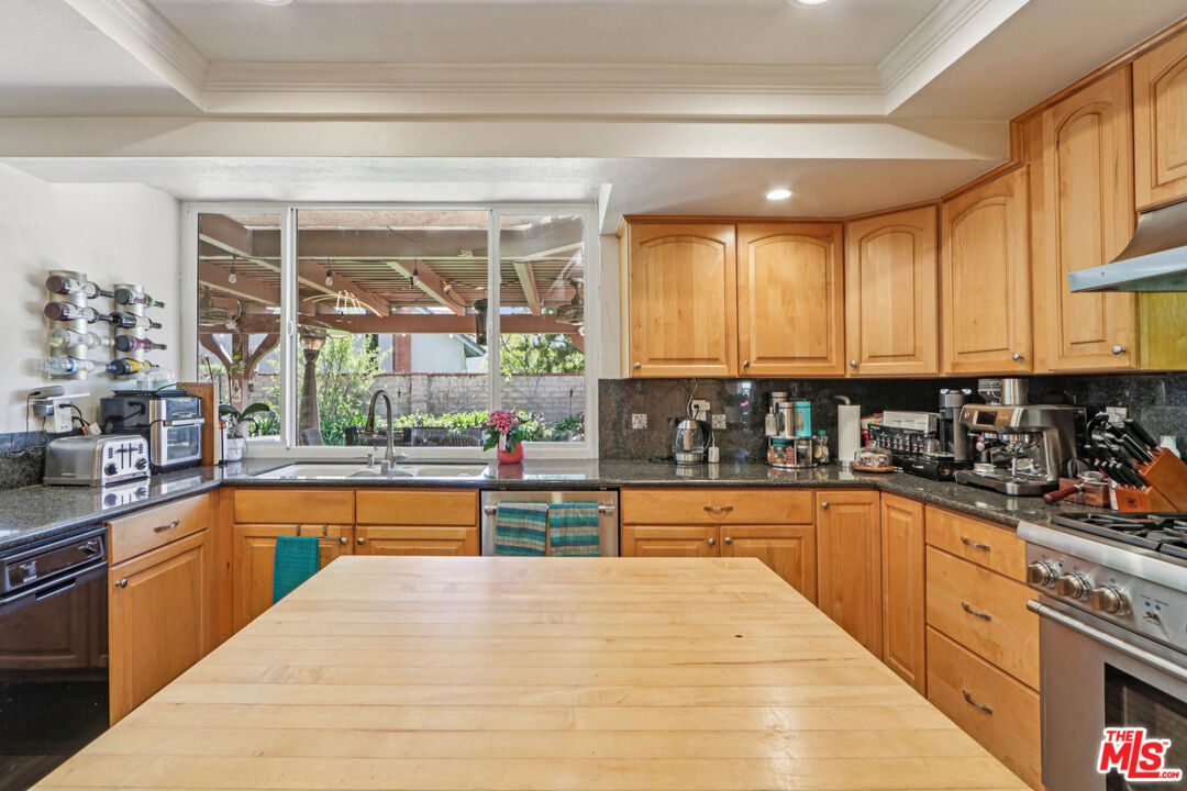 2136 McCrea Road Thousand Oaks, CA 91362 - Photo 23 of 66 a kitchen with stainless steel appliances granite countertop a stove a sink and a microwave