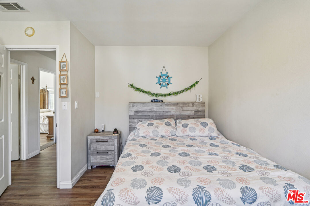 2136 McCrea Road Thousand Oaks, CA 91362 - Photo 49 of 66 a bedroom with a large bed and a chandelier