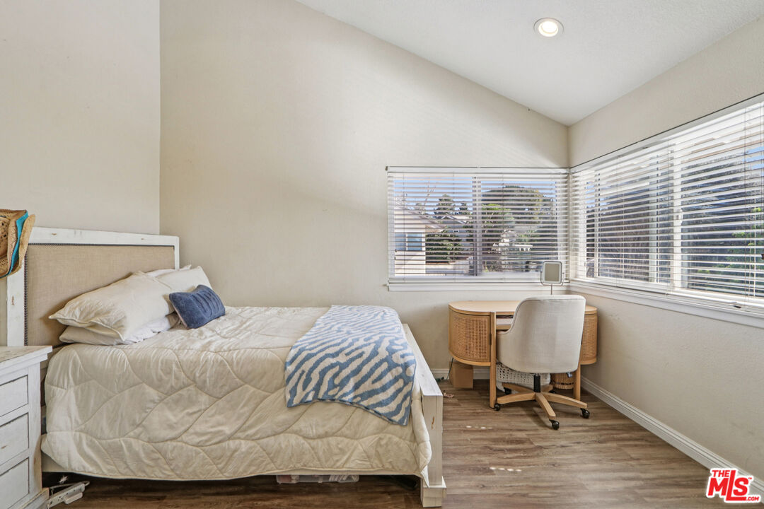 2136 McCrea Road Thousand Oaks, CA 91362 - Photo 54 of 66 a bedroom with a bed and wooden floor