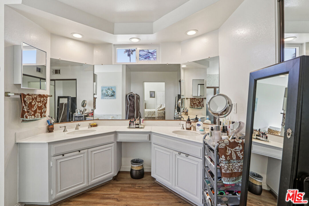 2136 McCrea Road Thousand Oaks, CA 91362 - Photo 61 of 66 a bathroom with a sink a mirror and a shower