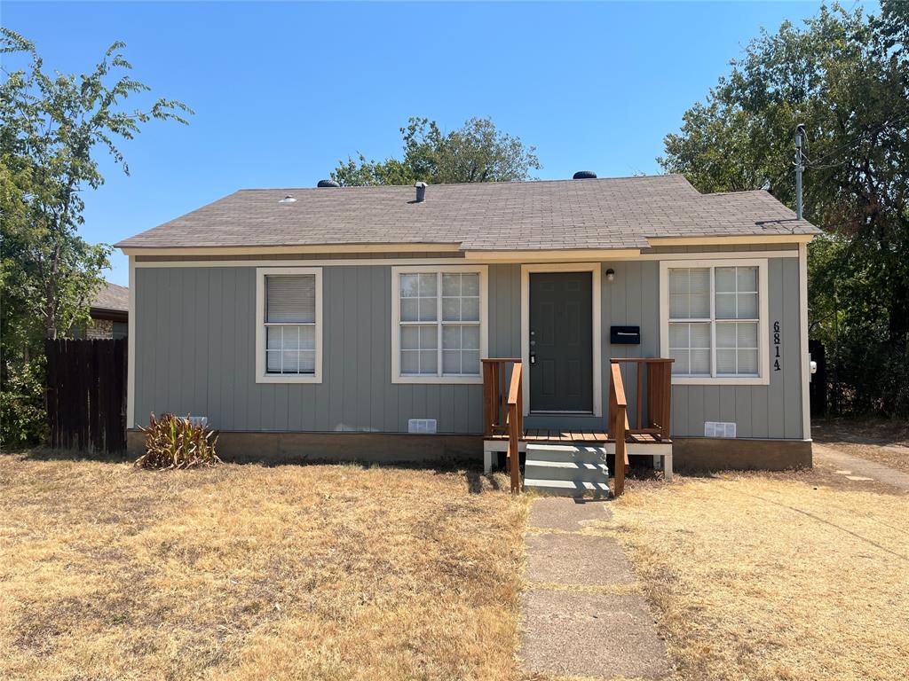 6814 Lockheed Avenue Dallas, TX 75209 - Photo 1 of 16 Single-story residence featuring light gray vertical siding, a dark gray entrance door, and white-framed windows