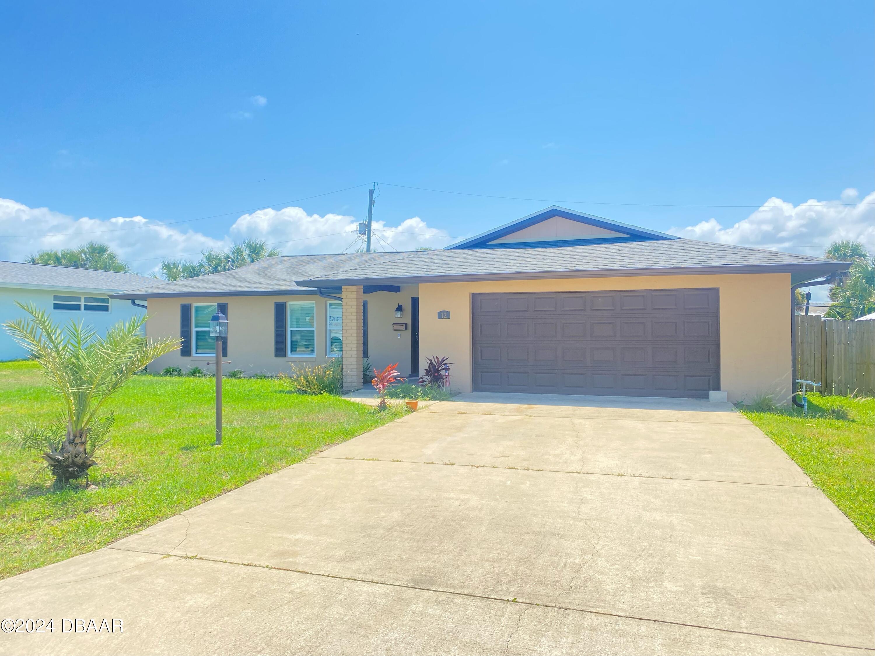 12 Ocean Crest Drive Ormond Beach, FL 32176 - Photo 1 of 31 a front view of house with garage and yard
