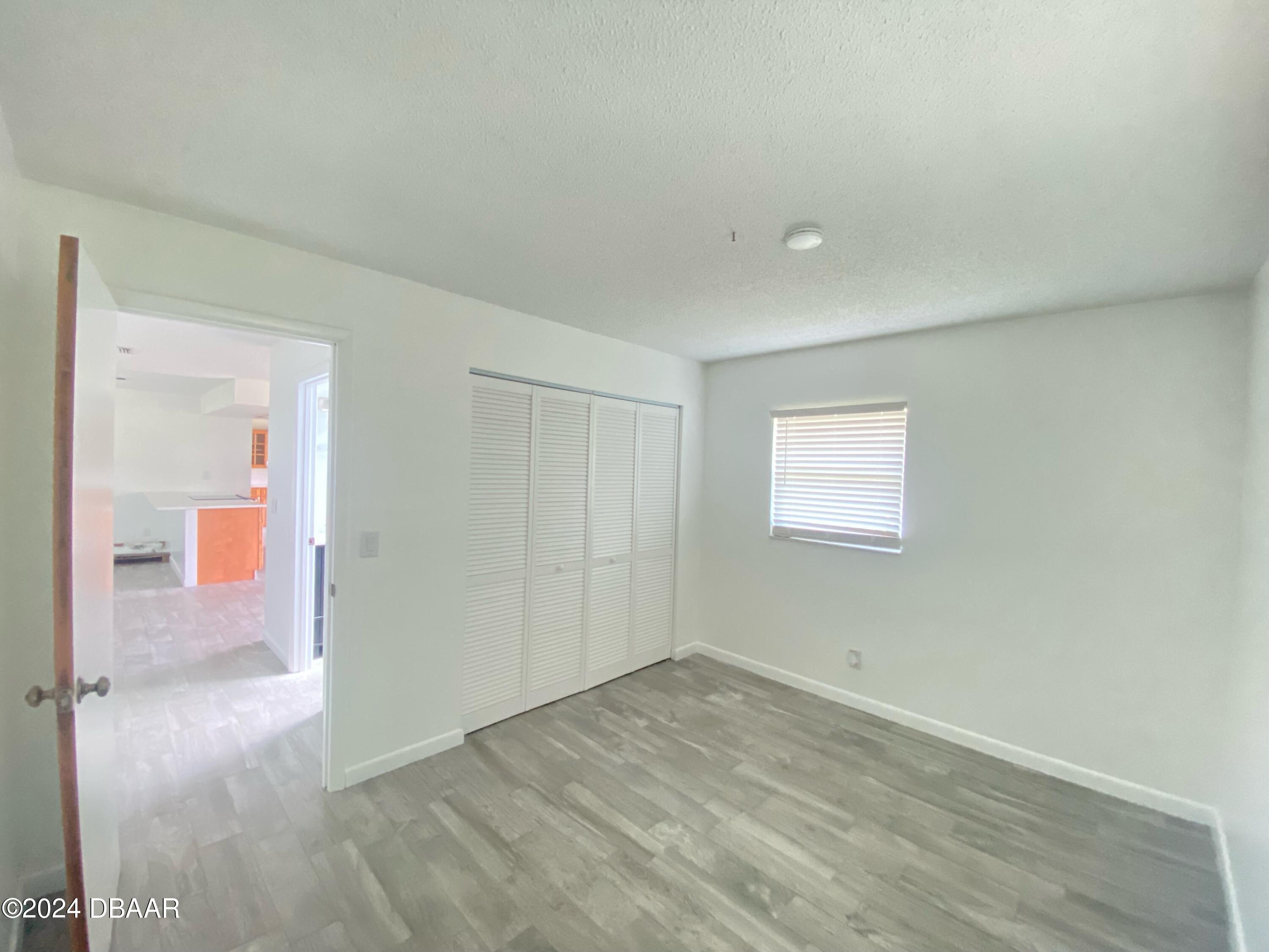 12 Ocean Crest Drive Ormond Beach, FL 32176 - Photo 18 of 31 an empty room with wooden floor and windows