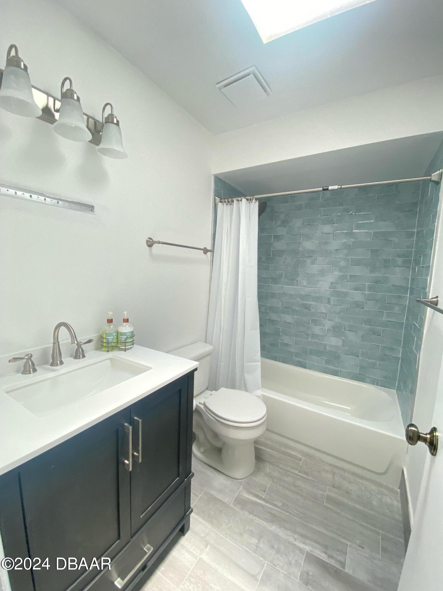 12 Ocean Crest Drive Ormond Beach, FL 32176 - Photo 19 of 31 a bathroom with a sink a toilet and shower