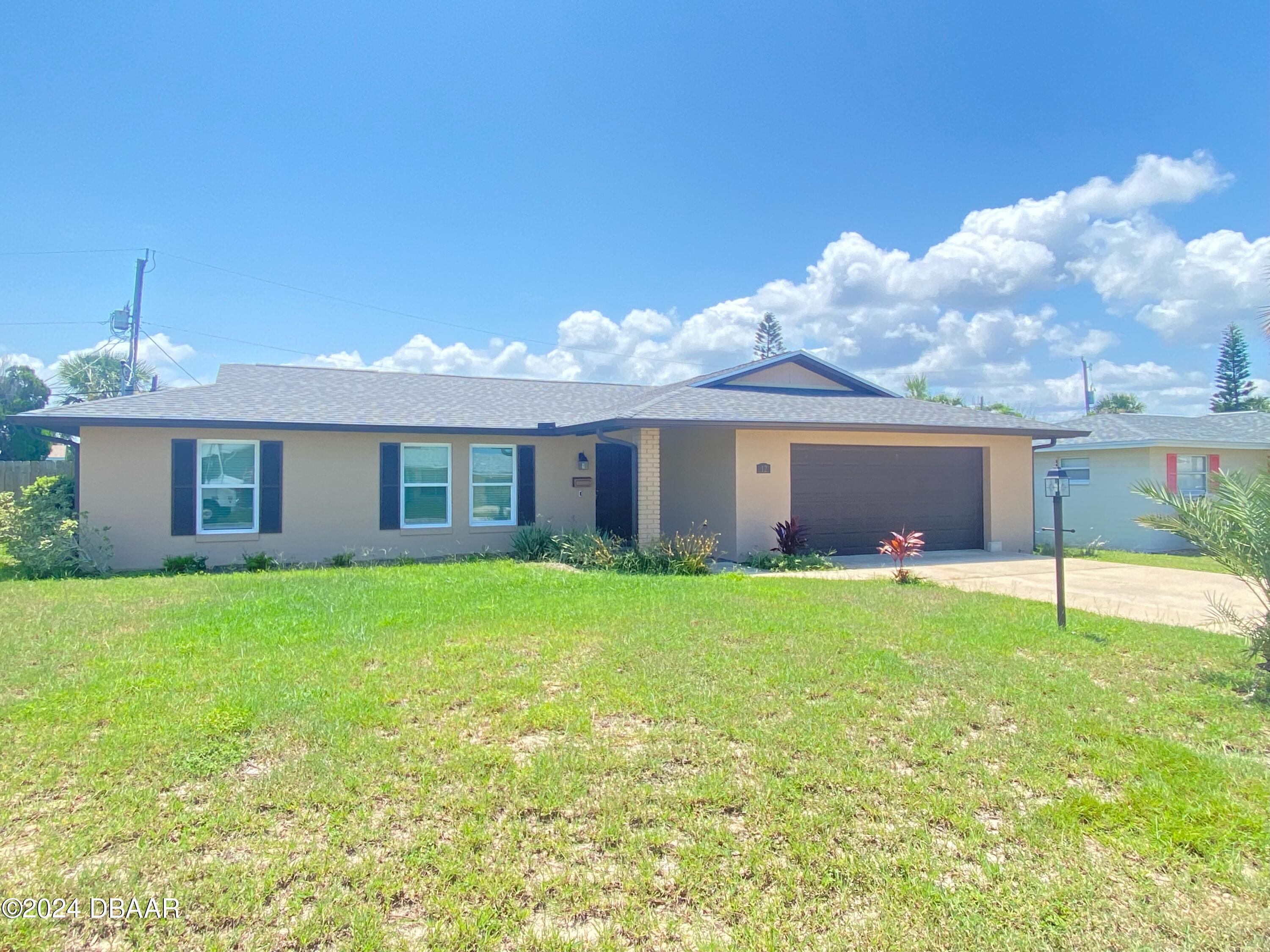 12 Ocean Crest Drive Ormond Beach, FL 32176 - Photo 2 of 31 a view of a yard with a house
