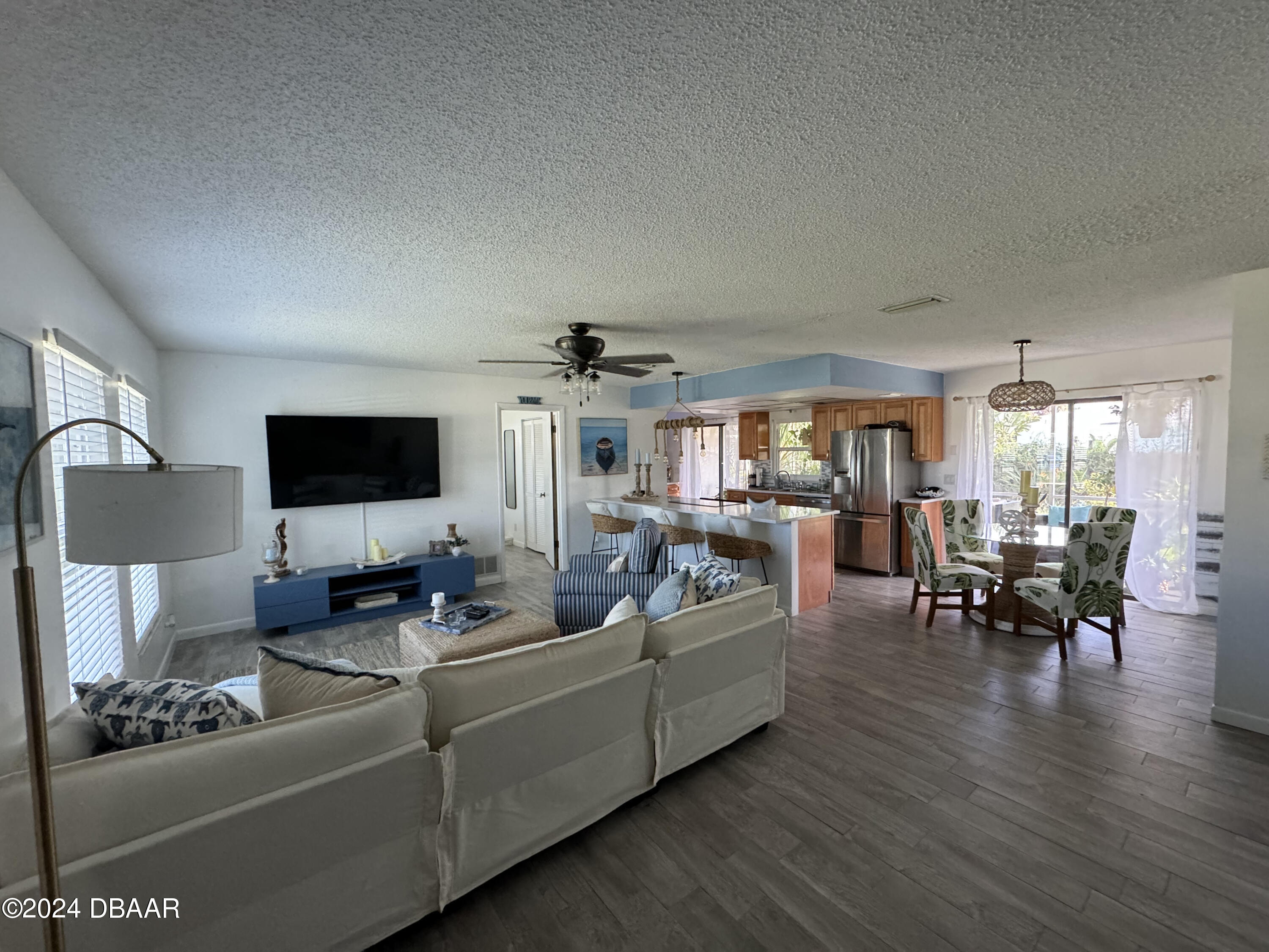 12 Ocean Crest Drive Ormond Beach, FL 32176 - Photo 23 of 31 a living room with furniture and a flat screen tv