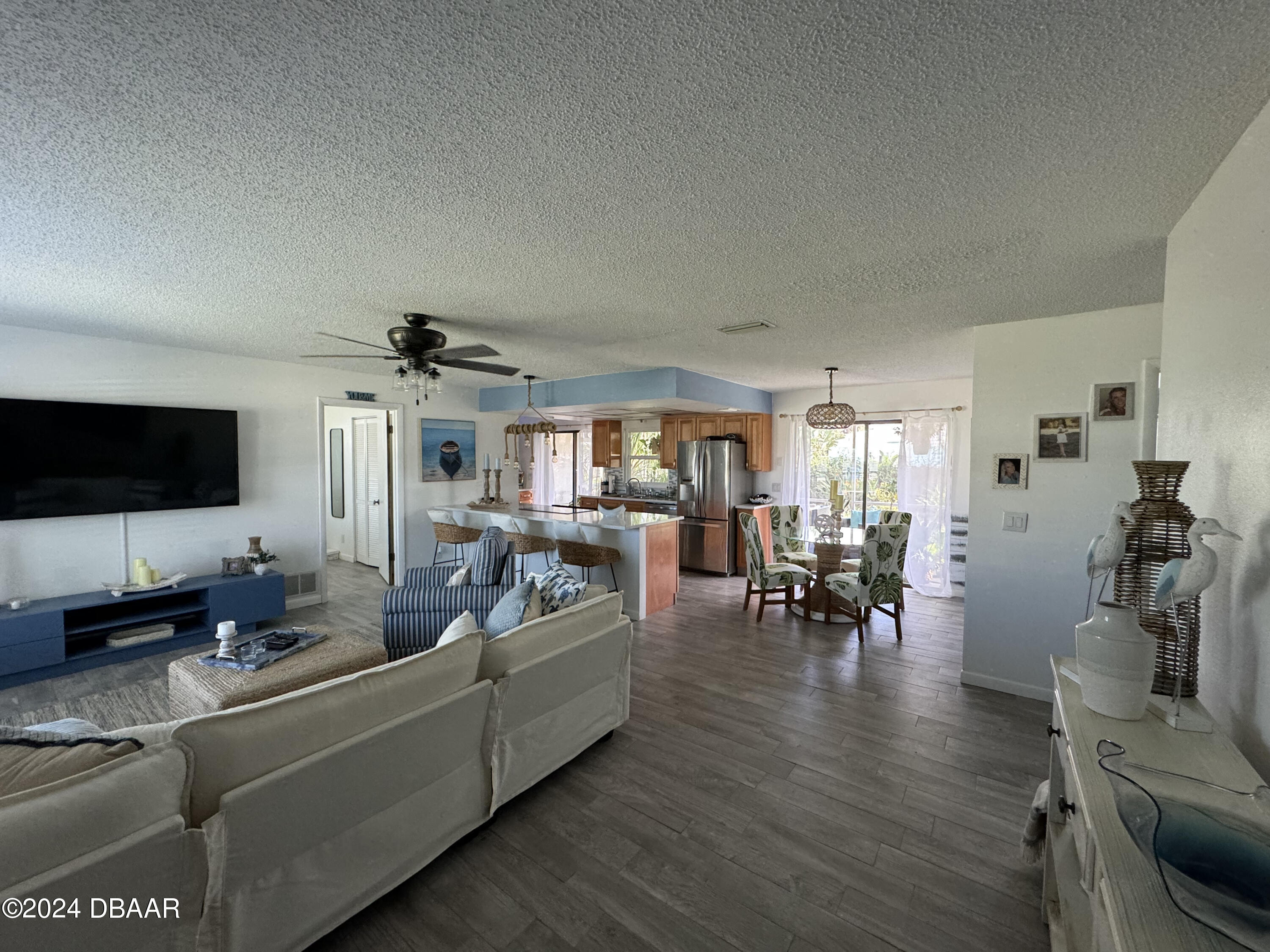 12 Ocean Crest Drive Ormond Beach, FL 32176 - Photo 24 of 31 a living room with furniture and a flat screen tv