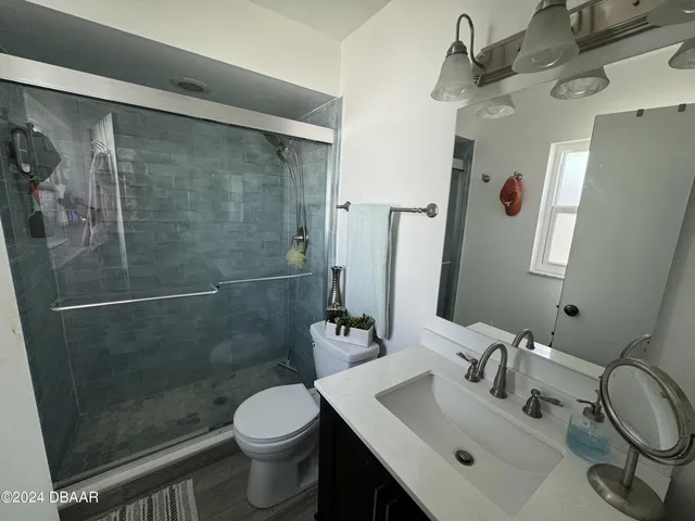 a bathroom with a sink toilet and shower