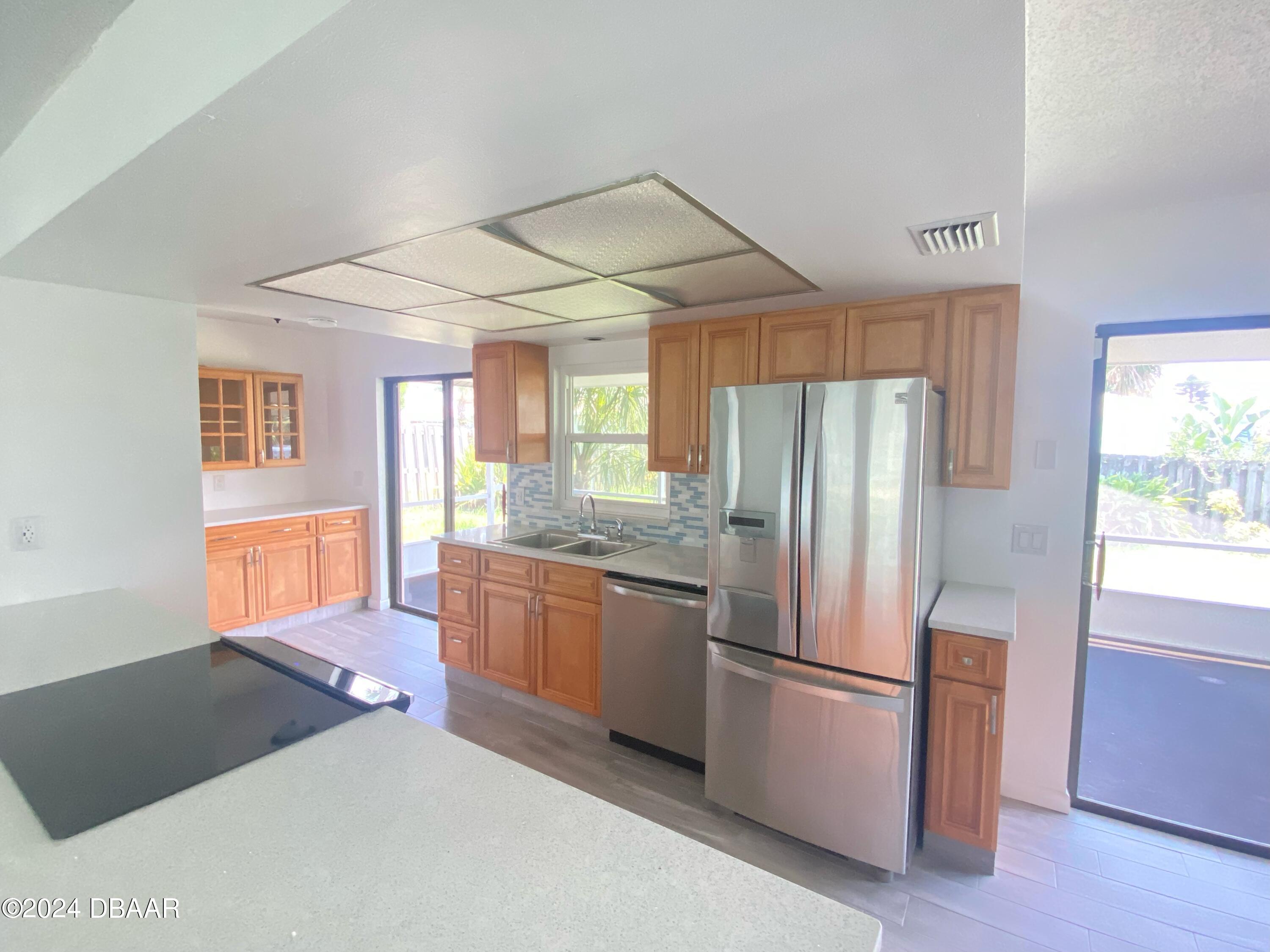 12 Ocean Crest Drive Ormond Beach, FL 32176 - Photo 6 of 31 a kitchen with stainless steel appliances granite countertop a refrigerator and a sink