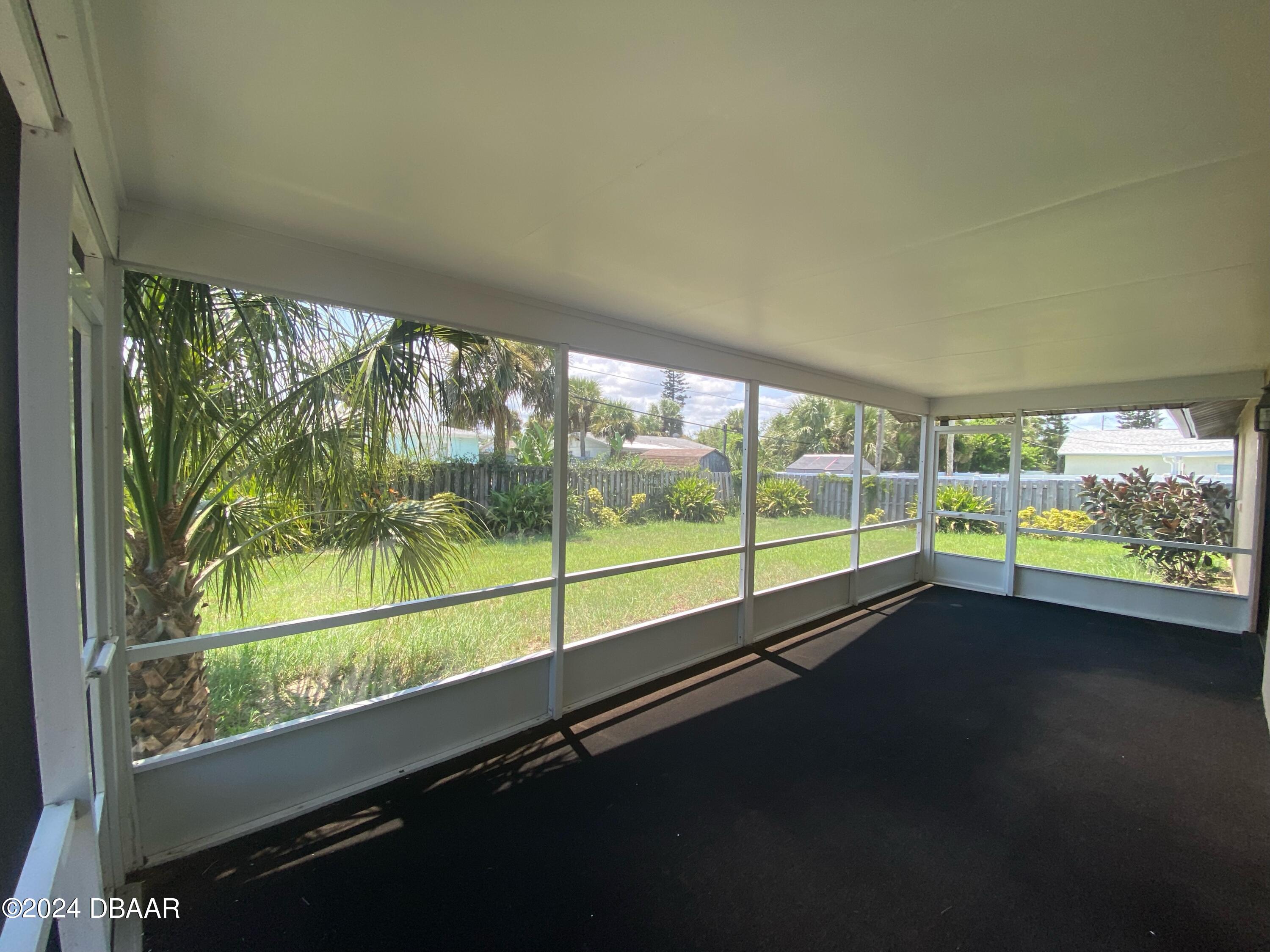 12 Ocean Crest Drive Ormond Beach, FL 32176 - Photo 9 of 31 a view of an empty room with a large window