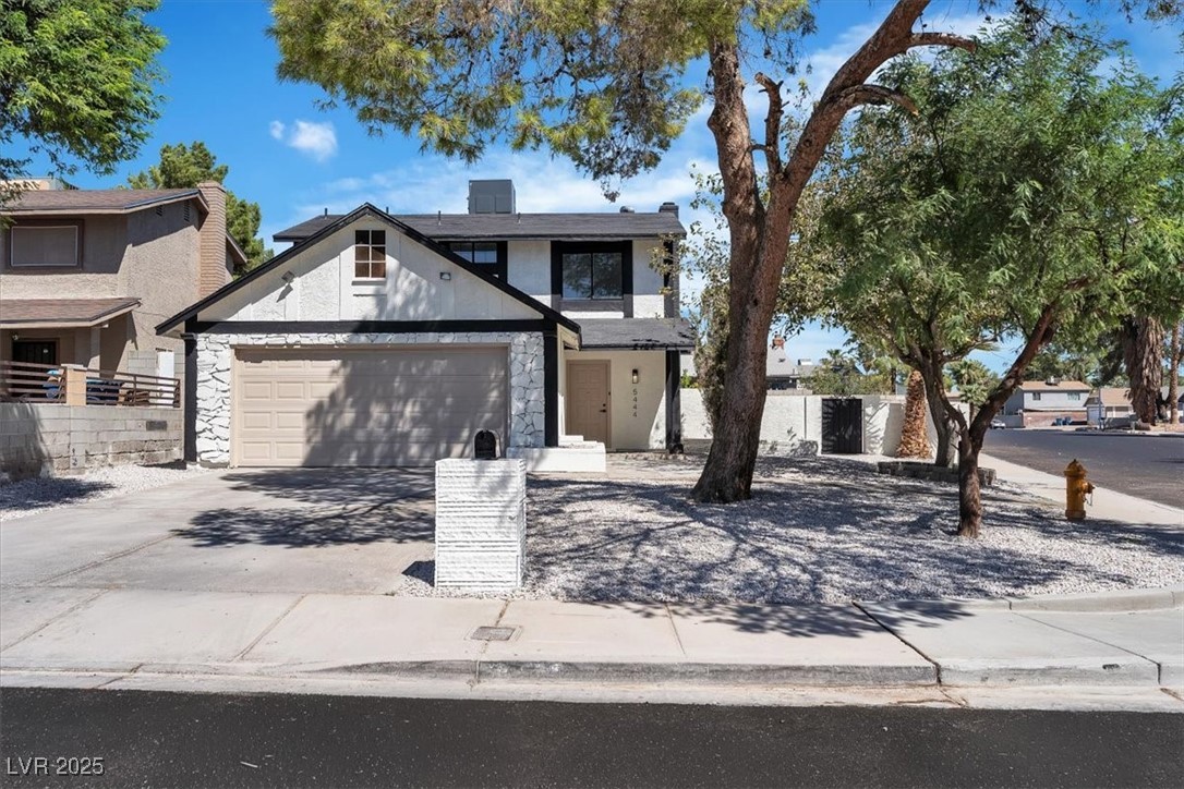 5444 Alpaca Circle Las Vegas, NV 89142 - Photo 1 of 1 View of front of house featuring driveway, stucco siding, a garage, and stone siding