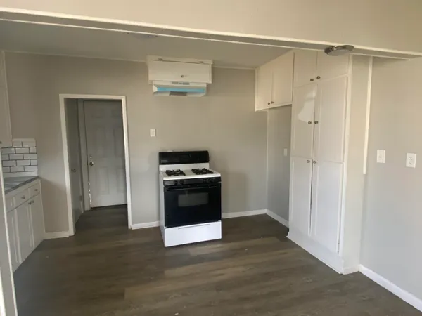 a kitchen with stainless steel appliances a refrigerator and a stove top oven