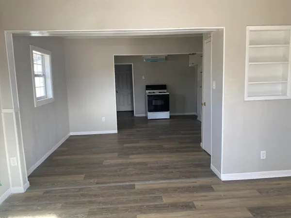 a view of a hallway with wooden floor and a fireplace