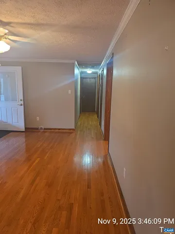 a view of hallway with wooden floor