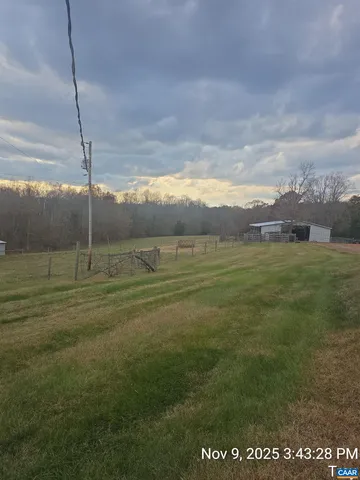 a view of a big yard with an ocean view