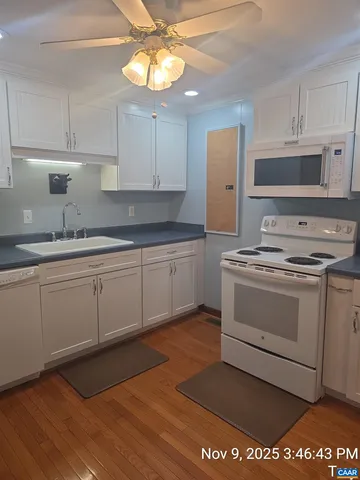 a kitchen with a stove cabinets and a sink