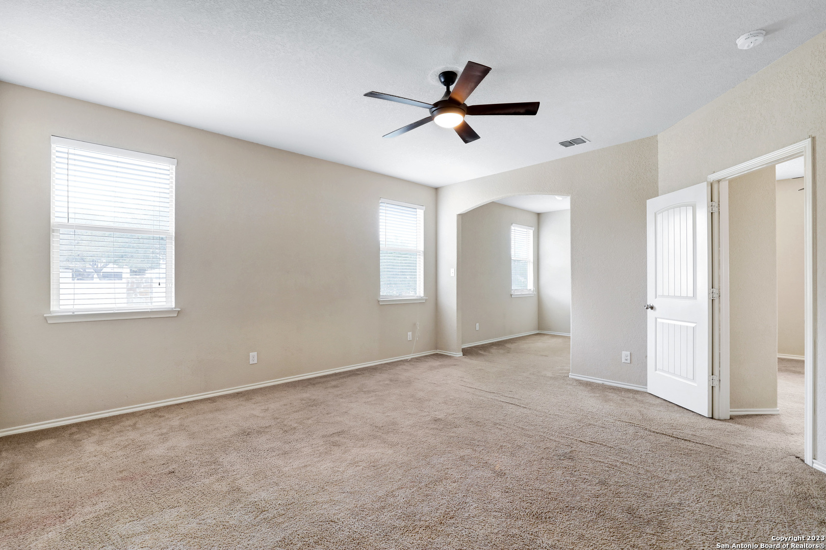 1331 Nicholas Manor San Antonio, TX 78258 - Photo 15 of 26 a view of a livingroom with a ceiling fan & windows