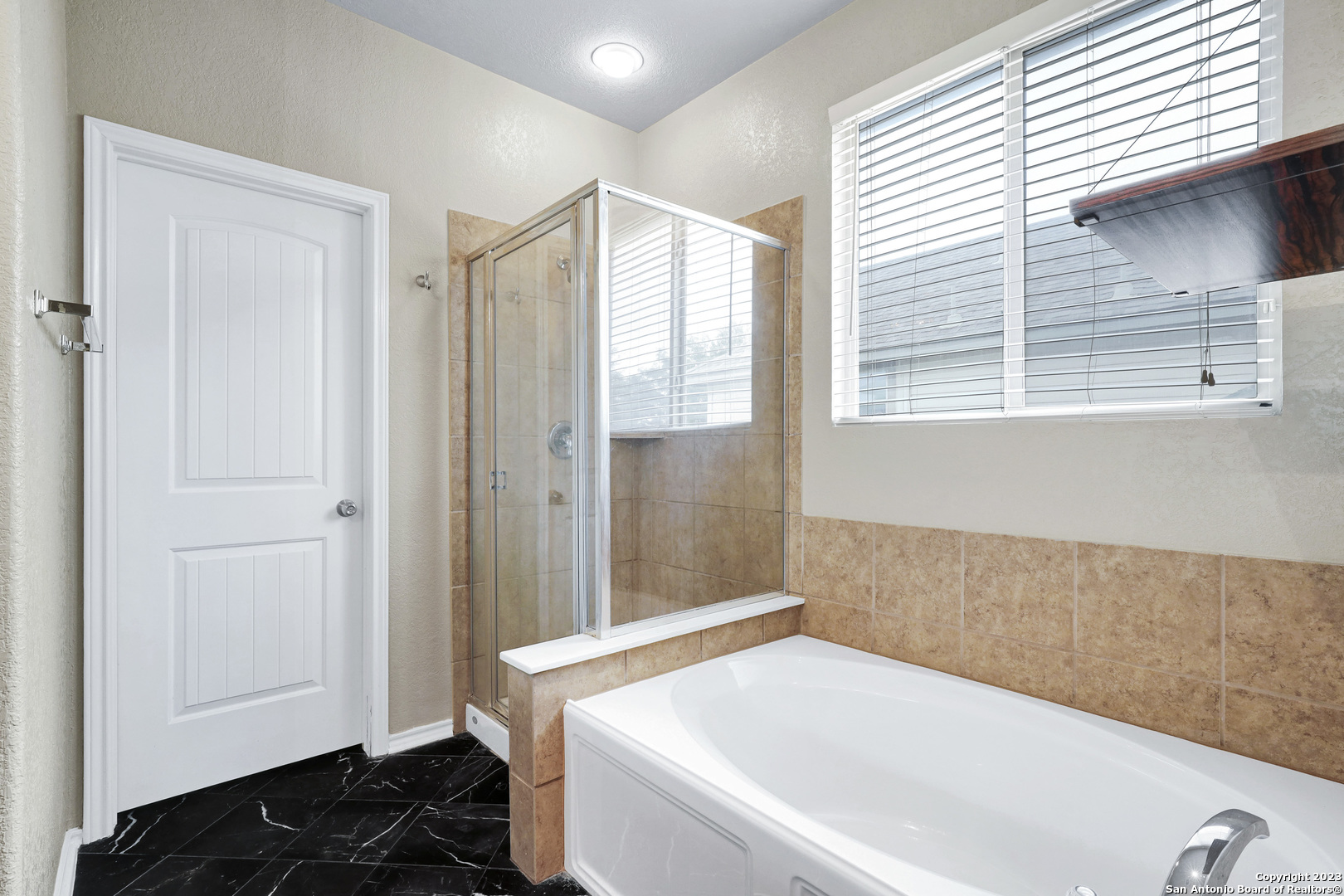 1331 Nicholas Manor San Antonio, TX 78258 - Photo 18 of 26 a bathroom with a bathtub and a shower