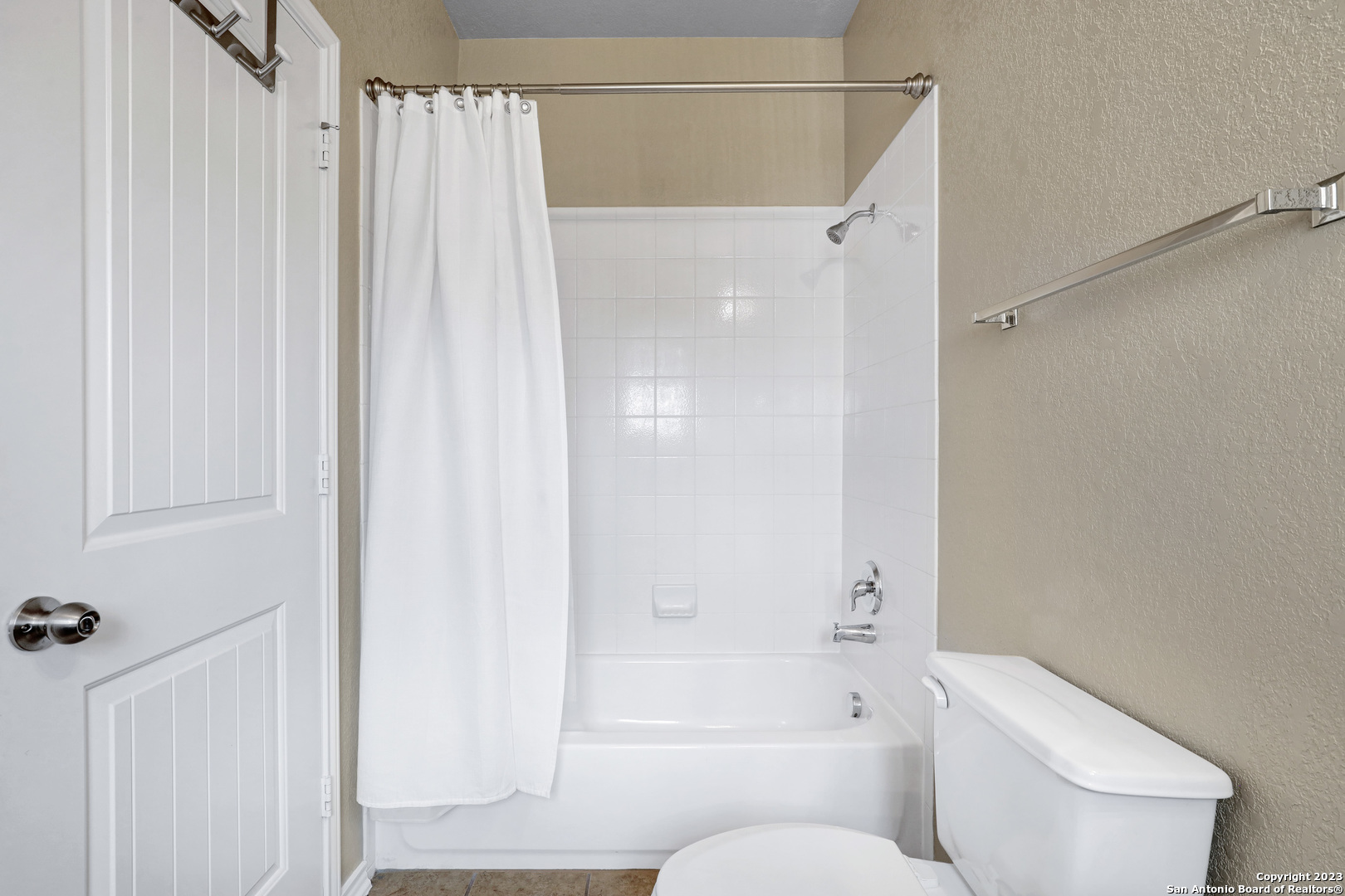 1331 Nicholas Manor San Antonio, TX 78258 - Photo 21 of 26 a bathroom with a shower curtain and a toilet