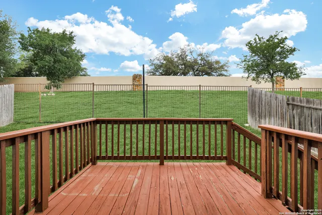 a view of deck with wooden floor and fence