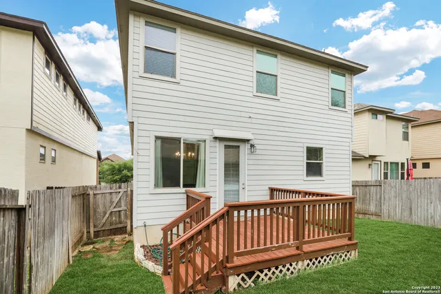 a view of a house with a wooden deck
