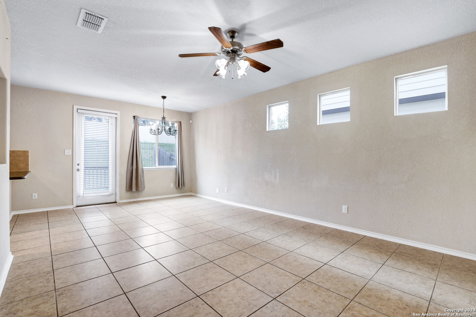 1331 Nicholas Manor San Antonio, TX 78258 - Photo 4 of 26 a view of an empty room with a ceiling fan and window