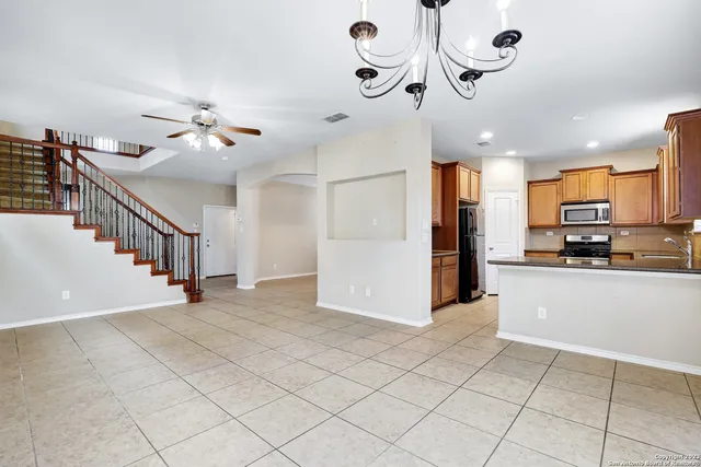 a view of a kitchen with furniture and stainless steel appliances