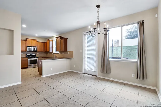 a large kitchen with kitchen island granite countertop a refrigerator and a sink