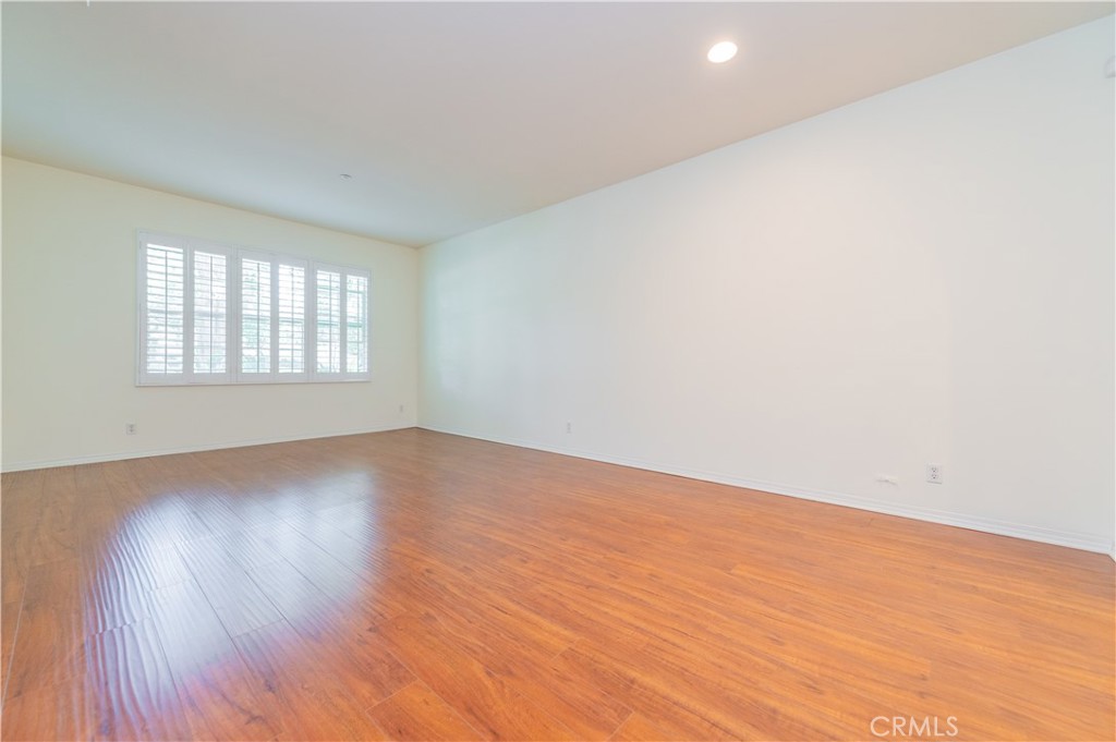 105 Hallmark Irvine, CA 92620 - Photo 11 of 32 an empty room with wooden floor and windows