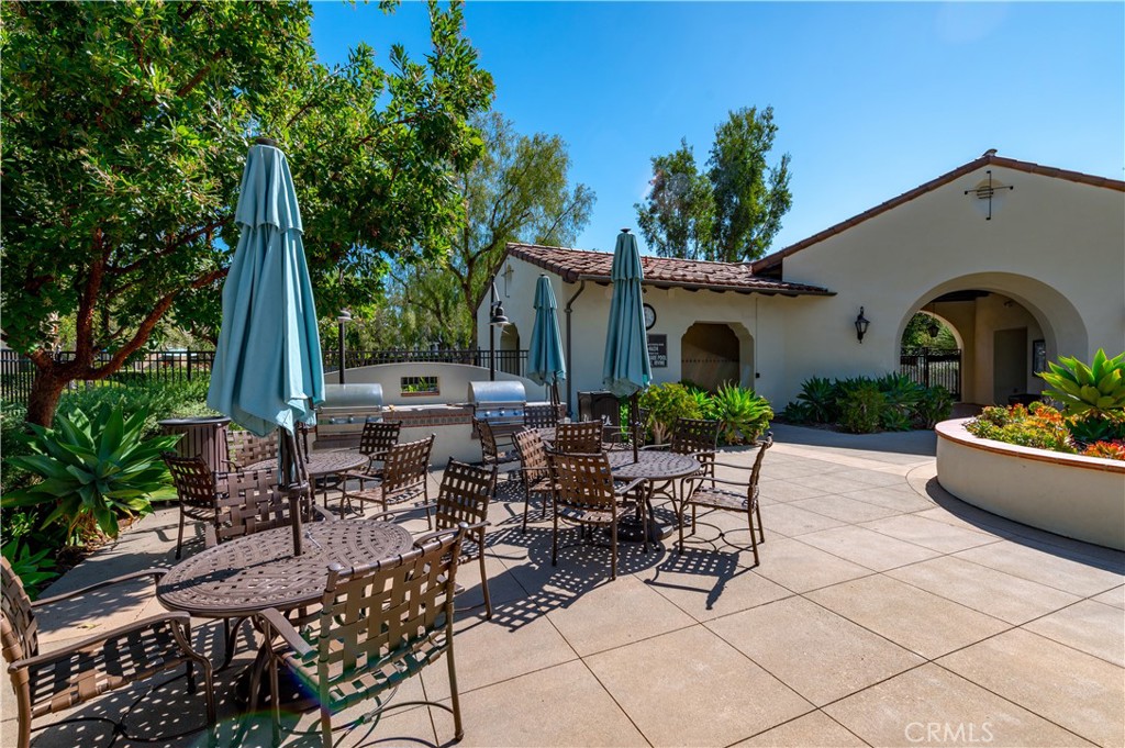 105 Hallmark Irvine, CA 92620 - Photo 22 of 32 a view of a patio with couches table and chairs and potted plants