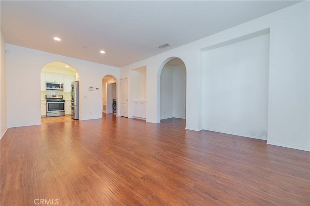105 Hallmark Irvine, CA 92620 - Photo 5 of 32 a view of empty room with wooden floor and fan