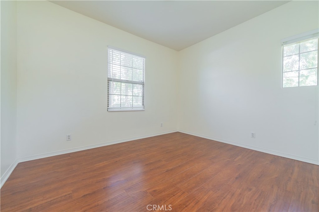 105 Hallmark Irvine, CA 92620 - Photo 10 of 32 an empty room with wooden floor and windows
