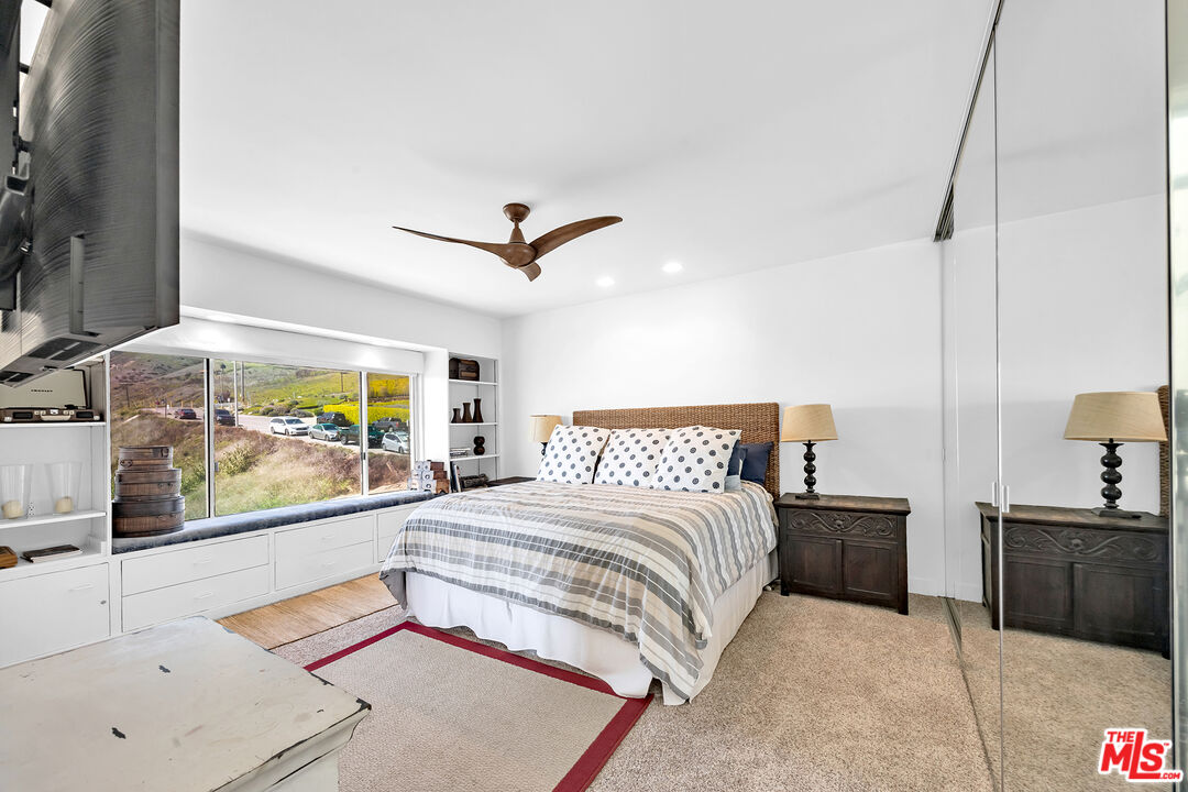 25444 Malibu Road Malibu, CA 90265 - Photo 14 of 15 a bedroom with a large bed and a large window