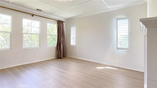 an empty room with a fireplace and sink