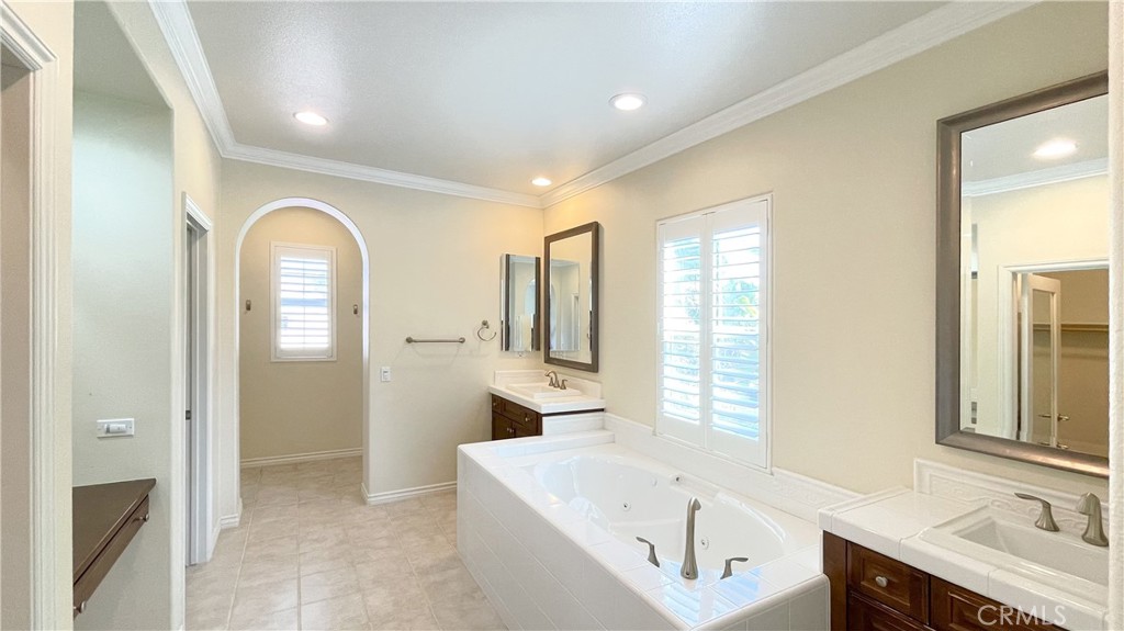 21 Vine Irvine, CA 92620 - Photo 23 of 37 a bathroom with a tub a sink and a large mirror