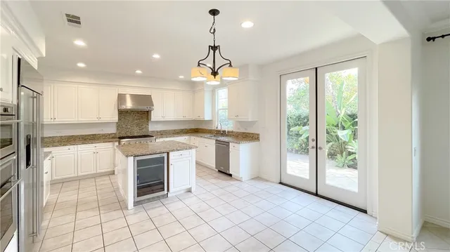 a kitchen with a stove a sink and a refrigerator