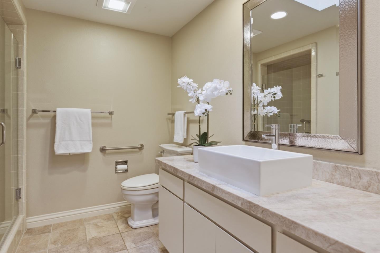 1057 Broncho Road Pebble Beach, CA 93953 - Photo 18 of 21 a spacious bathroom with a sink a toilet and a mirror