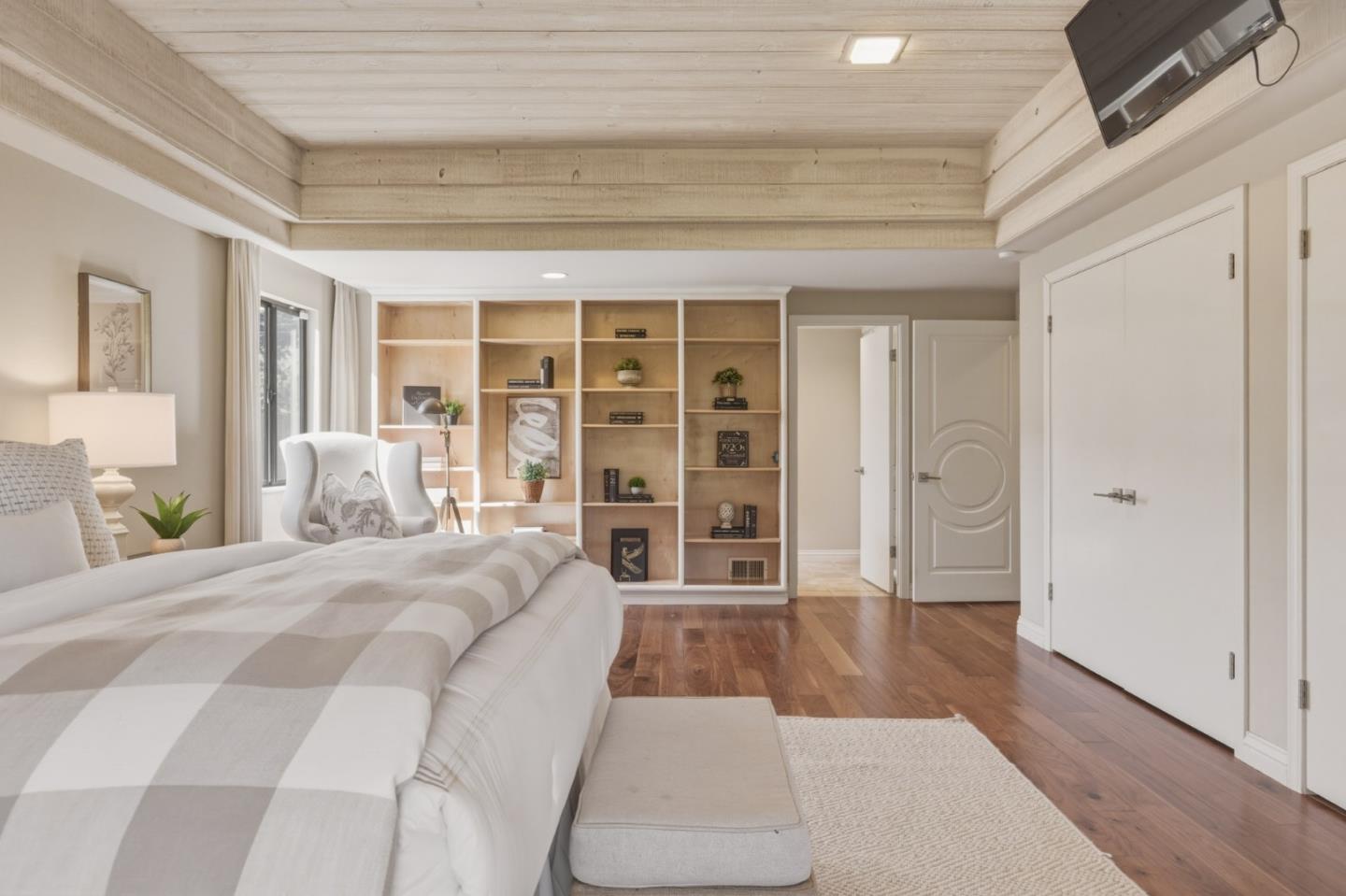 1057 Broncho Road Pebble Beach, CA 93953 - Photo 21 of 21 a spacious bedroom with a large bed and wooden floor