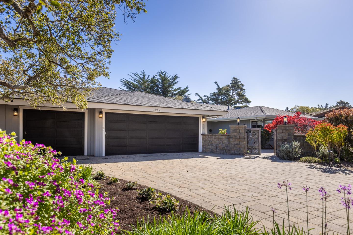 1057 Broncho Road Pebble Beach, CA 93953 - Photo 4 of 21 a front view of a house with a yard and garage