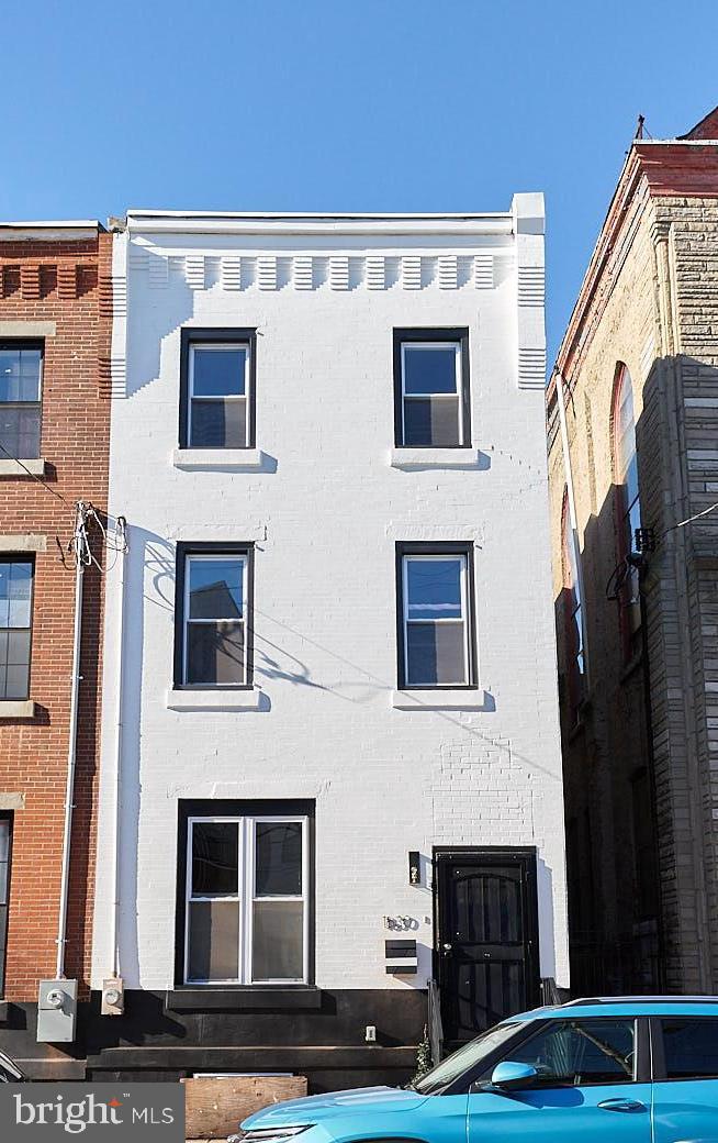 a front view of a house with stairs