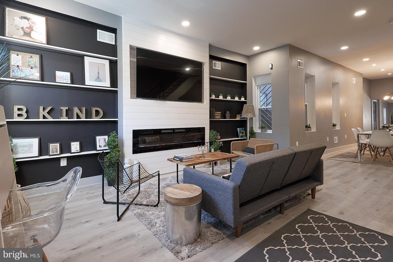 1630 North 26th Street Philadelphia, PA 19121 - Photo 4 of 50 a living room with furniture a rug and a flat screen tv