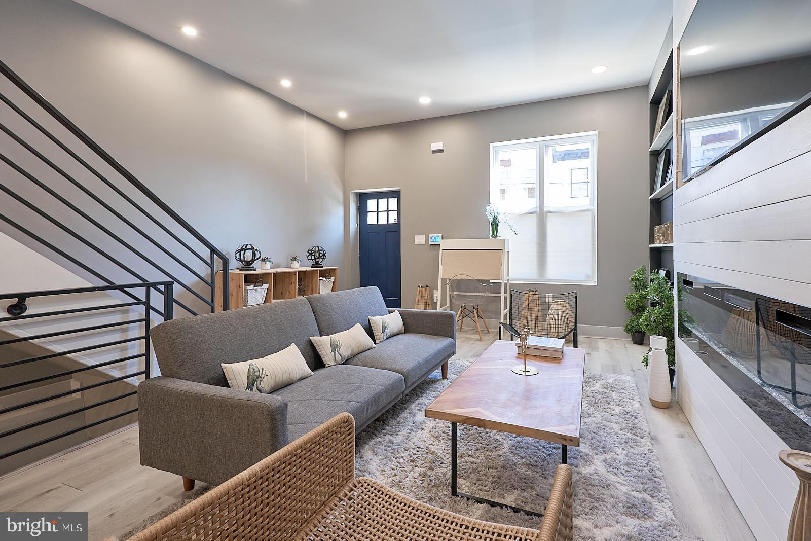 1630 North 26th Street Philadelphia, PA 19121 - Photo 7 of 50 a living room with furniture a fireplace and a table