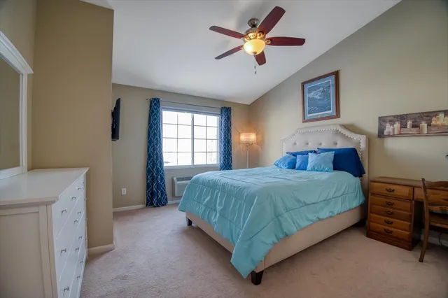 a bedroom with a bed and a ceiling fan