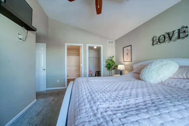 a bedroom with a large bed and a chandelier