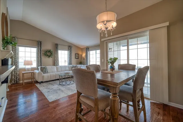 a view of a dining room with furniture wooden floor and chandelier