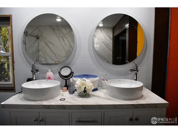 a white bath tub sitting in a bathroom next to a sink
