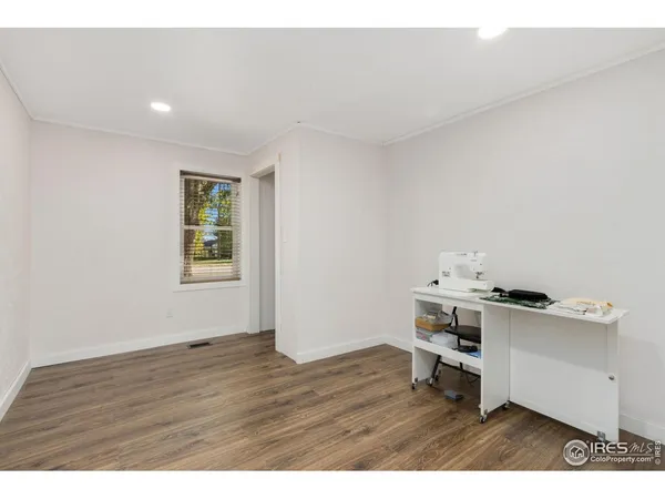 a bedroom with a bed with wooden floor